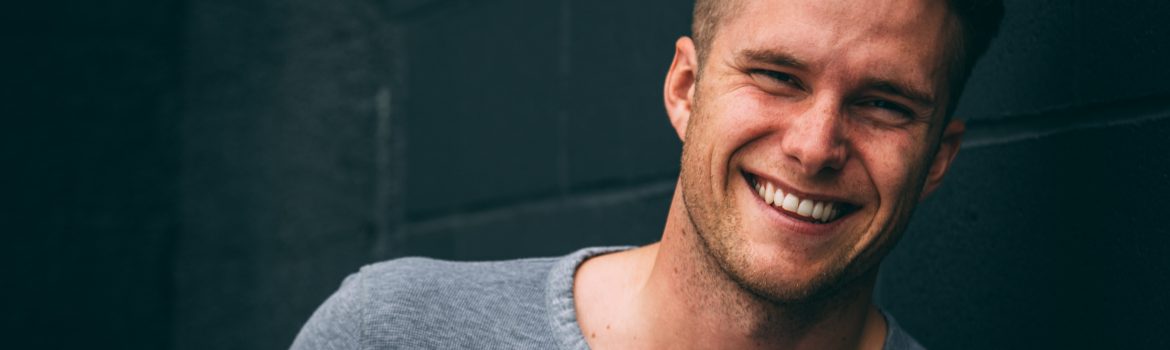 Handsome Young student smiling with blonde hair.