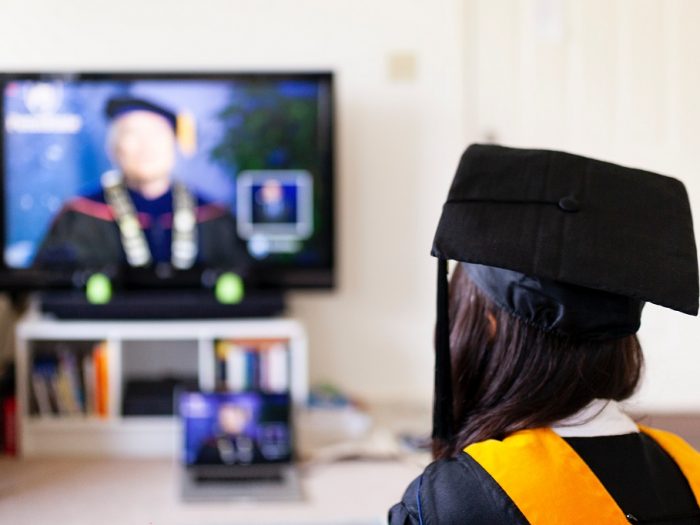 Girl who is a student watching a graduation ceremony.