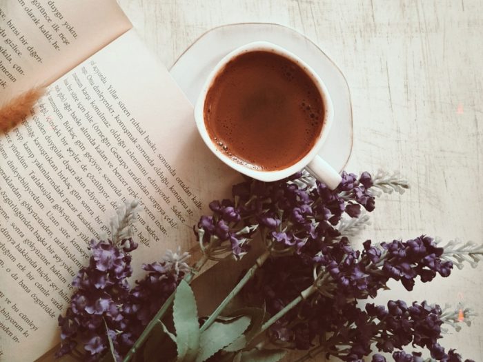 Cup of tea and book placed on the table