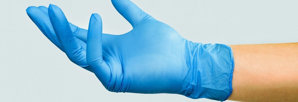 Hand in a blue medical glove