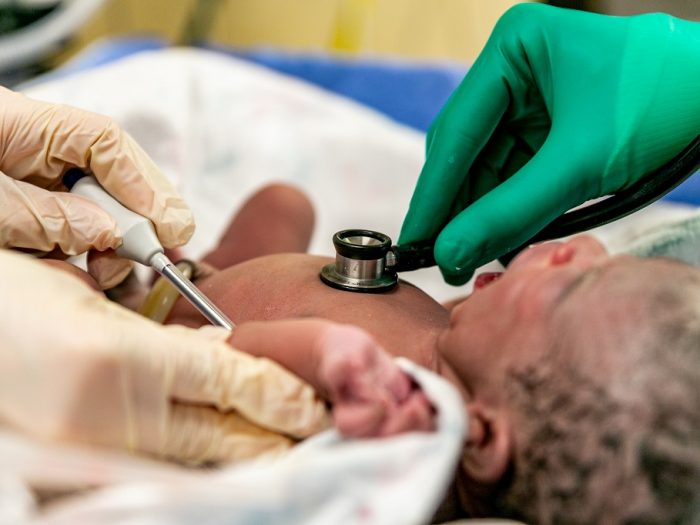A doctor is shecking a baby for a breath with Medical case and pillows and  stethoscope